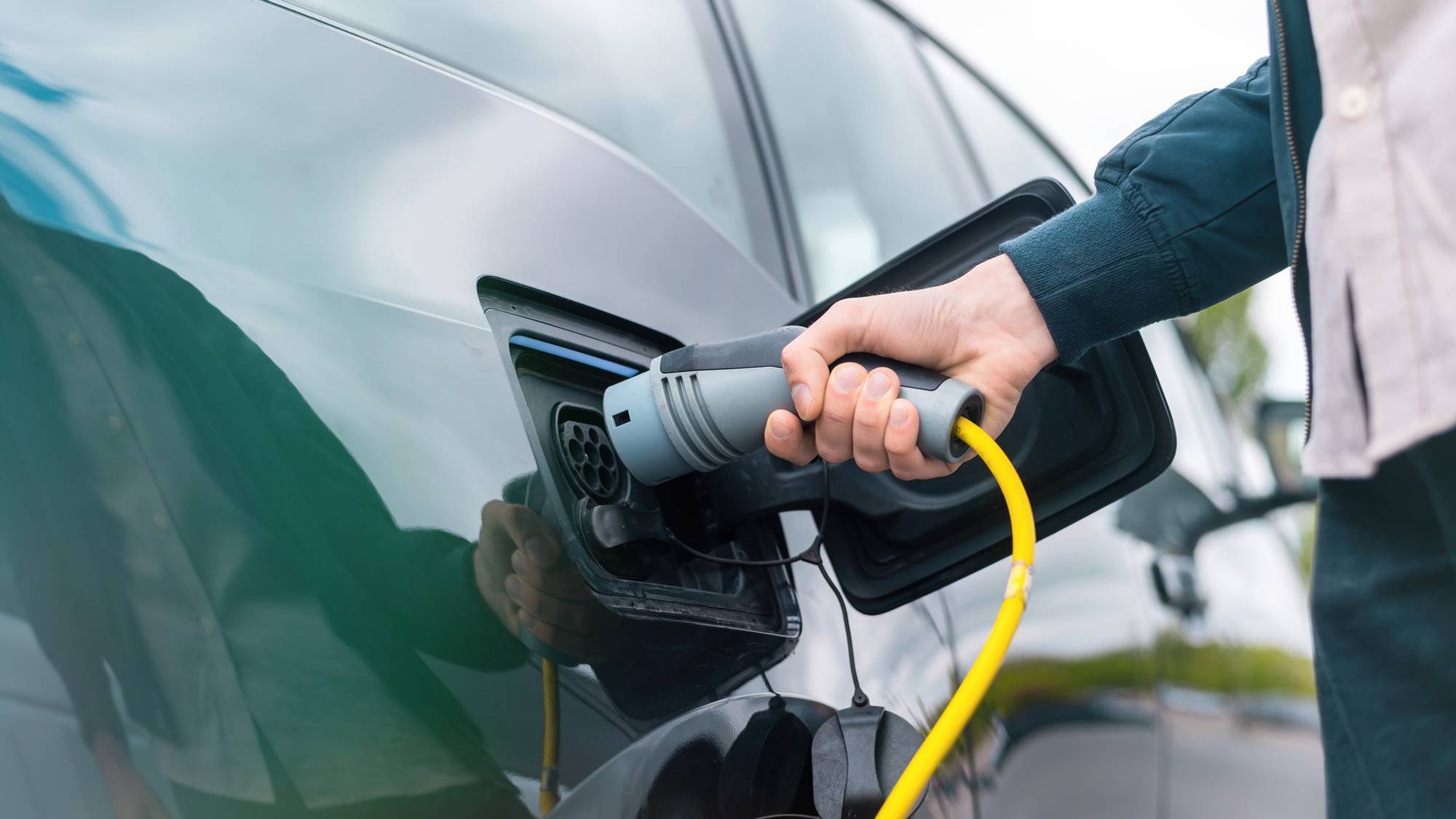 Man charging electric car